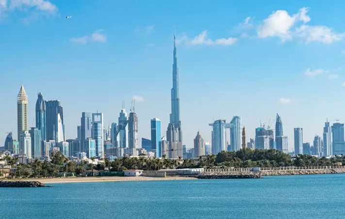 Dubai skyline at sunset showcasing the financial district and Burj Khalifa, symbolizing the UAE’s leadership in global investment and economic zones.